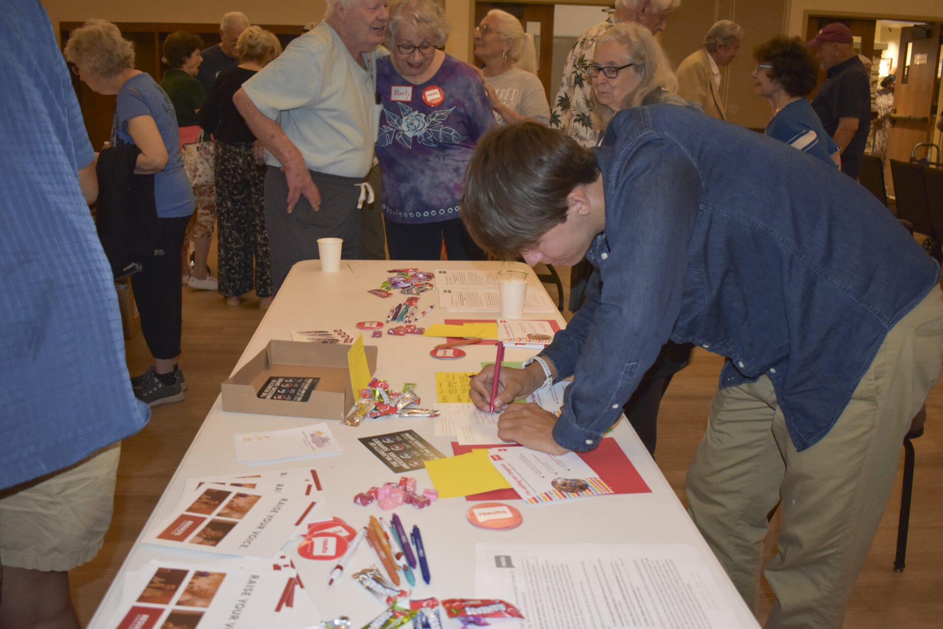 Attendee writes a postcard to Congress