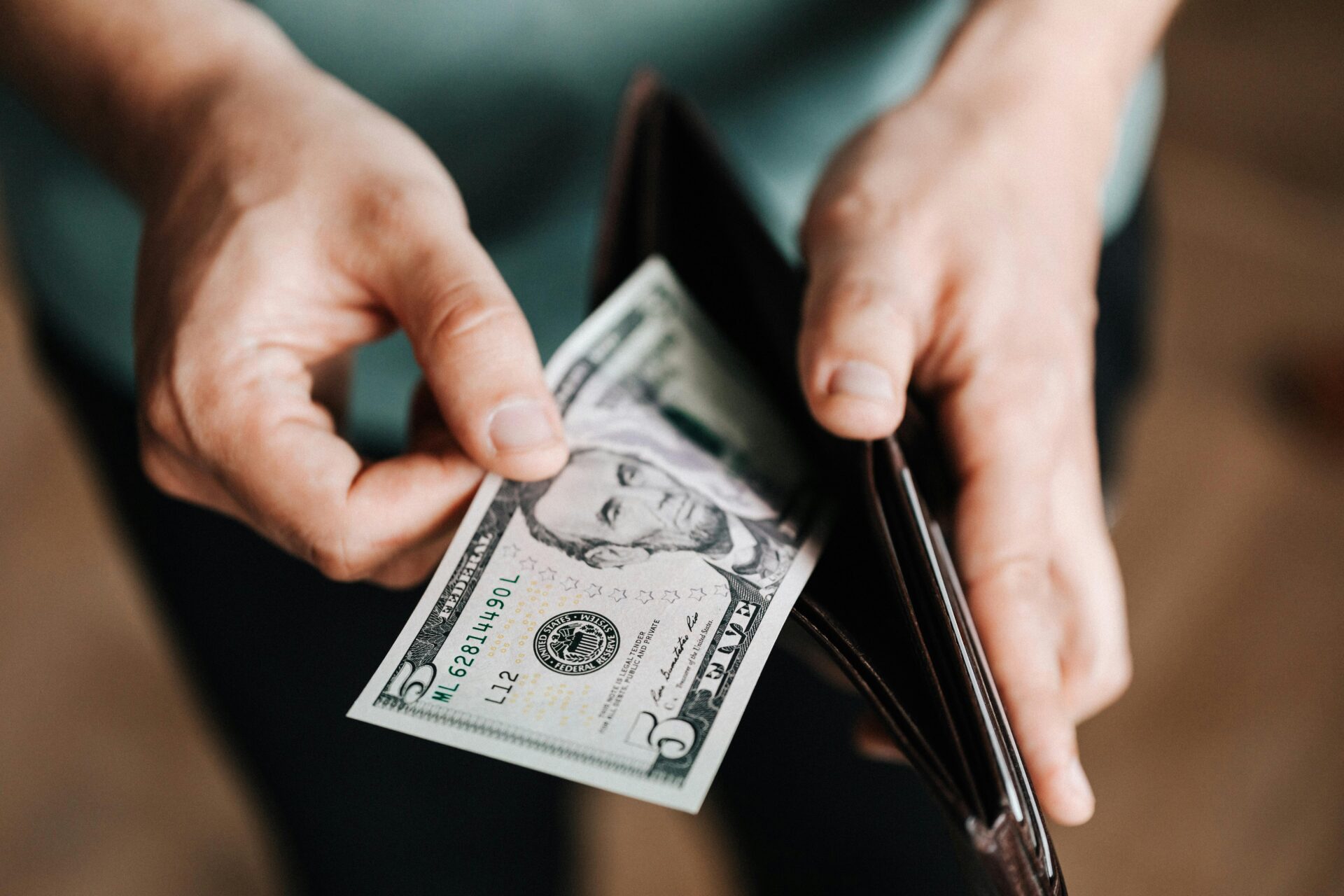 Person pulling money from a wallet