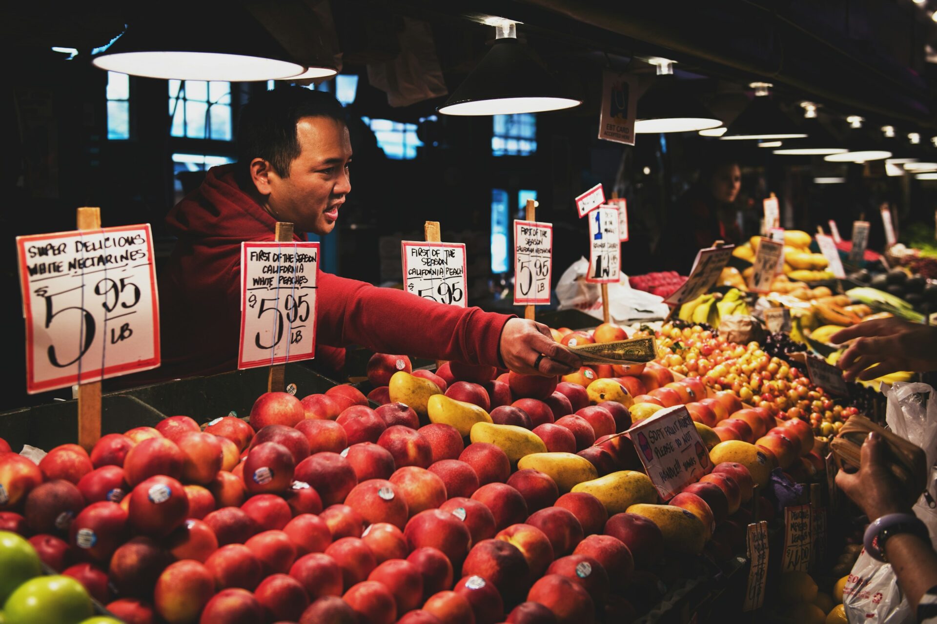 Person handing money over at farmer's market